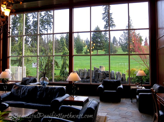 Olympic Lodge Lobby with full walls of windows opening a view to the golf course and Olympic mountains.